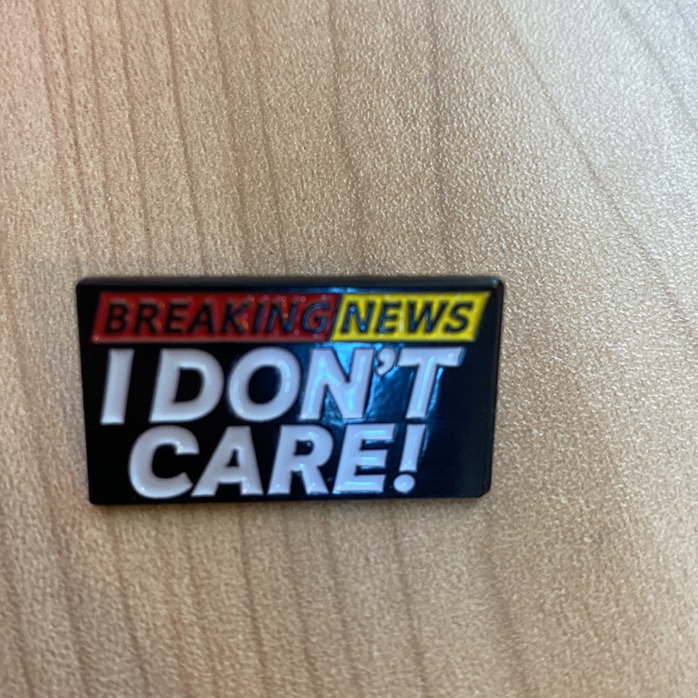 Funny “breaking news! I don’t care” enamel pin accessory